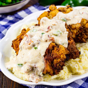 Chicken Fried Steak with Jalapeno Bacon Gravy- the southern classic gets even better when the gravy is flavored with jalapenos and bacon for a salty, spicy kick.
